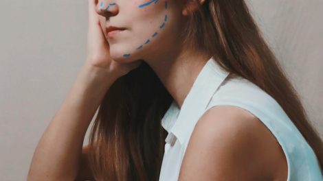 woman in white sleeveless shirt with blue eyes