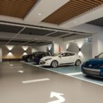Modern indoor parking garage with parked cars.
