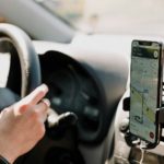 a person using a cell phone while driving a car